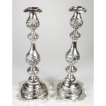 Two large silver candlesticks, hallmarked to the bases and sconces 'R&T, London 1911', both are of