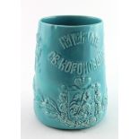 Russian interest. A commemorative green ceramic beaker with embossed decoration, by Kuznetsov,