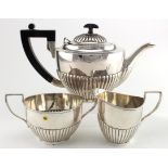 Silver three piece tea set, comprising teapot with wooden handle & finial, cream jug and sugar bowl,