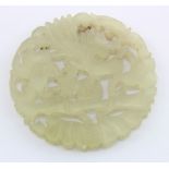 Jade. A Chinese jade carved roundel, with bird & floral decoration, diameter 50mm approx.