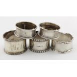 Five silver napkin rings, various types and hallmarks, including one matching pair hallmarked