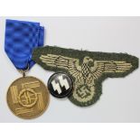 German SS 8 Year Long Service medal together with a SS sleeve badge, an enamelled lapel badge.