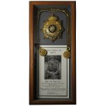 Cheshire Regiment officers gilt helmet plate and blue cloth helmet chin strap, mounted in frame with