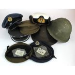 An assortment of military headwear including Hats, Caps, Berets and Helmets, including a nice WRNS