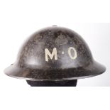 British home front resin helmet, no liner, with chinstrap. Painted black with metal crown and 'M.O.'