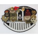 Assorted Badges. A brooched Middlesex Regiment cap badge, WW1 Suffolk Regiment embroidered slip-on