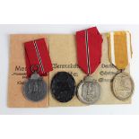 German Nazi Russian Front Medals x2 one maker marked '13', one with packet of issue, a West Walls