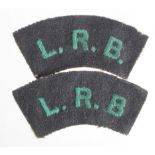 Pair of First World War London Rifle Brigade L.R.B. green-on-black shoulder titles. (2 items)