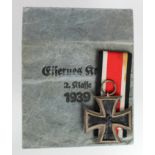 German Nazi Iron Cross 2nd Class in packet of issue, medal maker marked '65'.