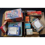 Toy boxes. A collection of approximately twenty-five empty original and reproduction cardboard boxes