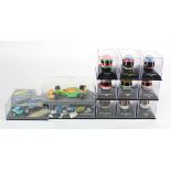 Minichamps. A collection of nine cased Minichamps helmets, together with three cased F1 racing car