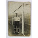 England player John Davison standing between goal posts in England kit. A rare RP postcard as he