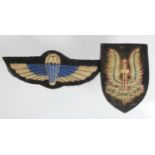 Badges an SAS Beret badge and Jump wings, cloth, both heavily worn.