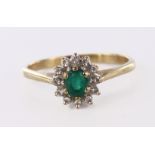 9ct yellow gold cluster ring set with central oval emerald surrounded by twelve diamonds totalling