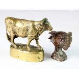 Car Mascots (possibly) comprising one brass cow and one bronze bird. There are initials on the