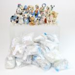 Wade. A collection of over sixty Wade figurines & Whimsies, including Disney, Hanna Barbera, etc.,