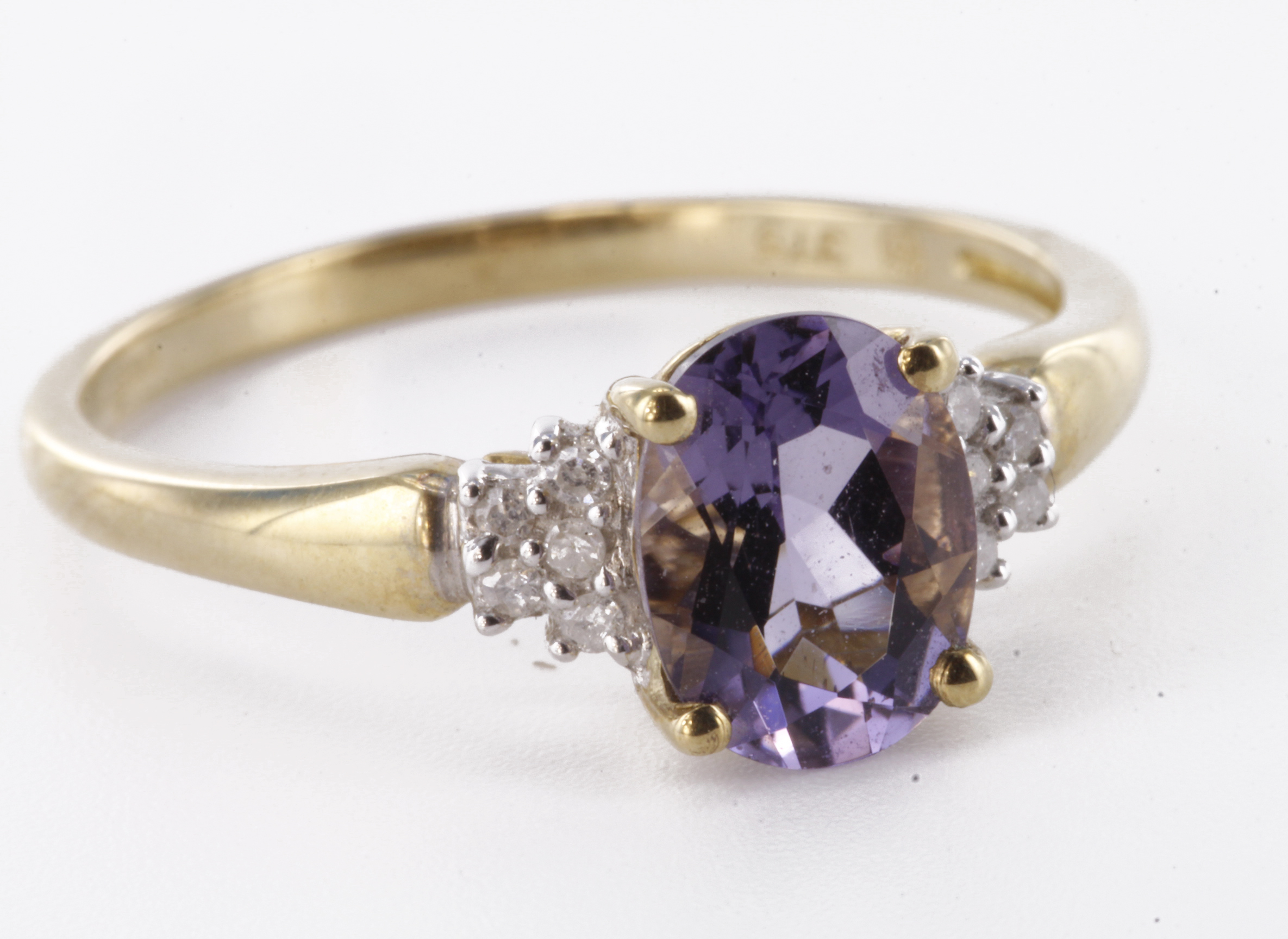 9ct yellow gold iolite and diamond dress ring with oval central iolite bordered on each sholder in a