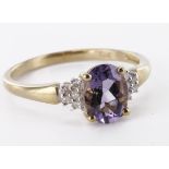 9ct yellow gold iolite and diamond dress ring with oval central iolite bordered on each sholder in a