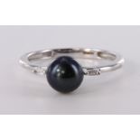 9ct white gold cultured black pearl ring with single baguette cut diamond either side, finger size