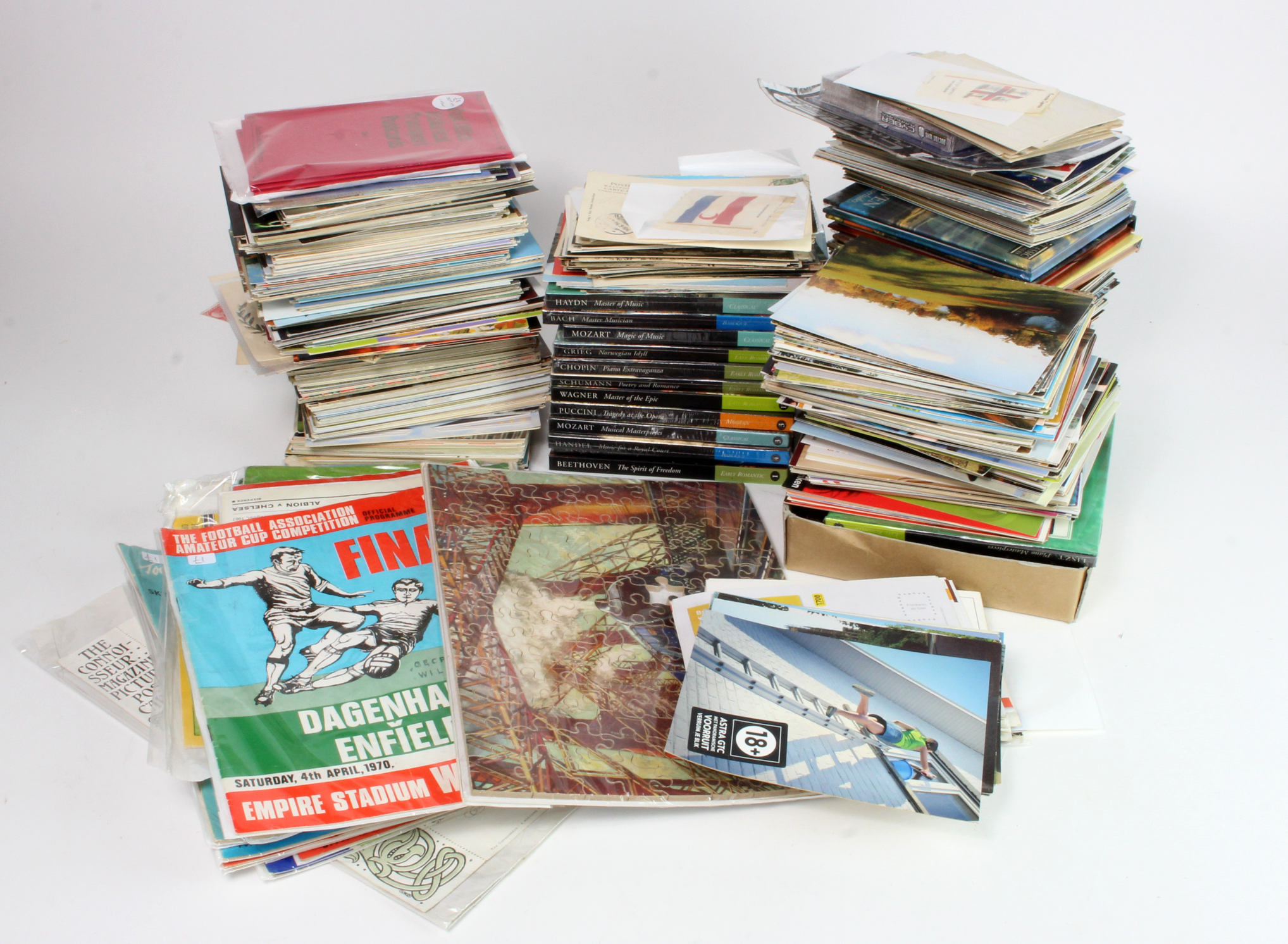 Mixed collection in crate, brass & metal figures, postcards, postal history, jigsaws, football