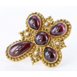 Tests as 16-18ct yellow gold ornate stylised cross brooch set with five cabochon cut garnets and