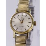 Ladies gold plated Omega De Ville mechanical wind wrist watch on expanding strap, chapagne dial with