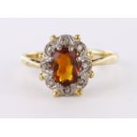 9ct yellow gold cluster ring set with central oval topaz with diamond accent surround, finger size