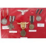 German Nazi medals x5 and Eagles x2. Note: items high quality replicas. (7)