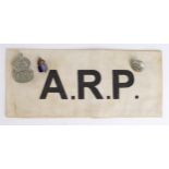 ARP cloth armband, plus two badges and a button. (4)