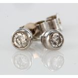 9ct white gold diamond solitaire stud earrings with rub over setting, total diamond weight approx.