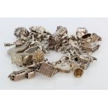 Silver / White metal charm bracelet with a good mixture of charms / non silver coins attached