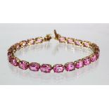 9ct yellow gold "tennis" bracelet set with oval pink Sapphire stones with box clasp and safety,