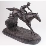After E. Loiseau. A large bronze depicting a horse & jockey, taking a jump, signed 'E Loiseau', on a
