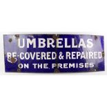 Enamel Sign. An original blue & white enamel sign 'Umbrellas Re-covered & Repaired on the Premises',