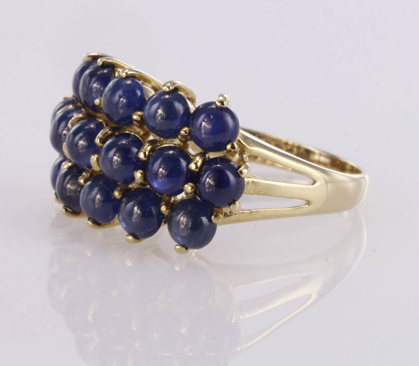 9ct yellow gold dress ring set with three rows of sapphire cabochons, finger size R, weight 4.9g