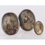 Three miniature portraits comprising of a pair of Mughal Style paintings in white metal oval