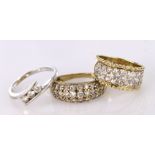 Three 9ct rings set with cz to include a white gold three stone ring and two yellow gold three row