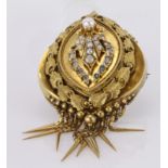 Yellow metal large ornate brooch set with seed pearls, accented by clear and green stones with a