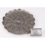 White metal filigree dish, diameter 13cm approx., together with a silver novelty matchbox holder '