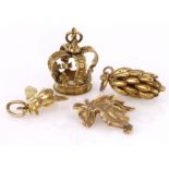 Four 9ct yellow gold charms to include a crown, leaf, bee and bunch of bananas, total weight 16.9g