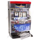 Fruit Machine. A Japanese Beatles fruit machine, with key & a collection of tokens, height 80cm,