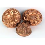 Three copper jelly moulds, circa late 19th to early 20th Century, largest height 10cm, length