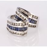 14ct white gold ribbon ring set with central row of baguette cut sapphires bordered on both sides by