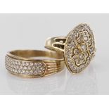 Two 9ct yellow gold rings set with cz to include marquise shaped dress ring and three row band ring,