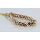 9ct yellow and white gold twisted rope and chain bracelet with bolt ring catch and safety chain,