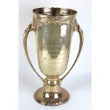 Large silver twin handled trophy, stamped 'Sterling' to base (American), ornately decorated with