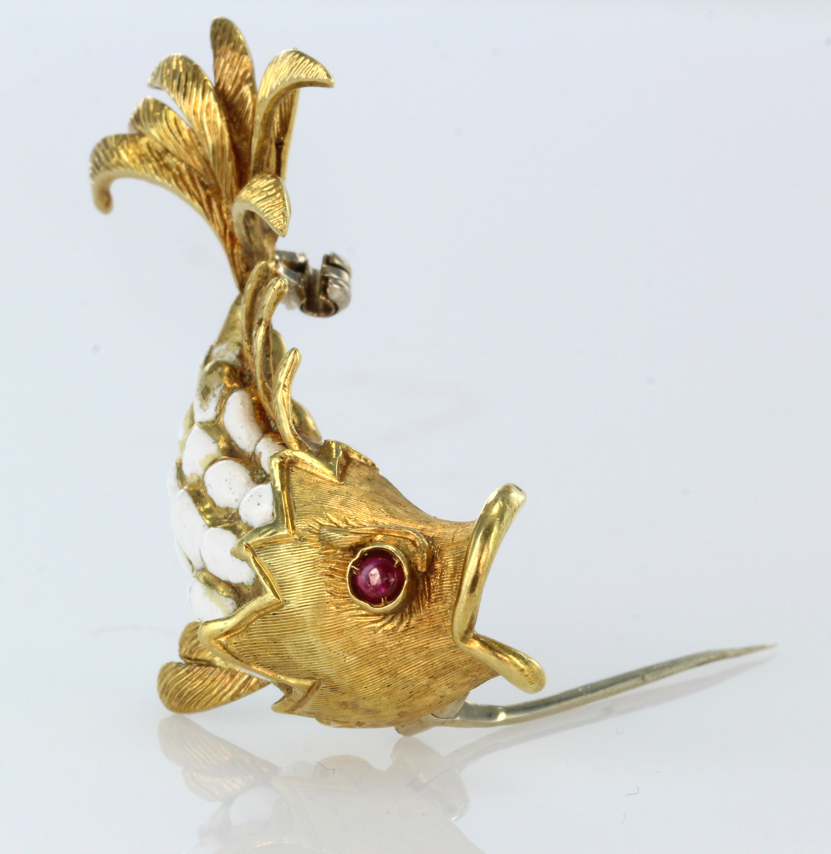 18ct yellow gold brooch in the shape of a leaping fish with a ruby eye and white enamel scales, - Image 2 of 2