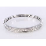 18ct white gold hinged bangle with box clasp and double safety catch, set with a central channel set