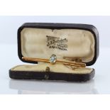 9ct hallmarked bar brooch set with an oval cut blue stone. In its original ? Box