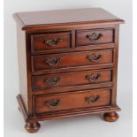 Small mahogany table cabinet, comprising of five drawers, raised on four ball feet, circa early 20th